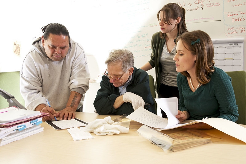 A group of people working on a project in a classroom